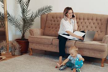 beautiful business woman working at home. multi tasking, freelance and motherhood concept