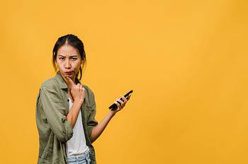 thinking dreaming young asia lady using phone with positive expr